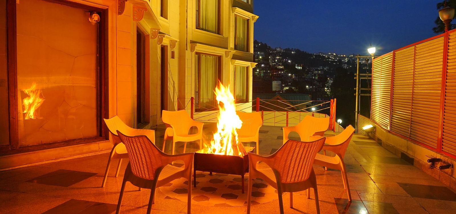 A bonfire with chairs arranged around it at DLS Hotels The Rock Castle